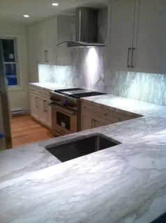 Devine Marble & Granite logo