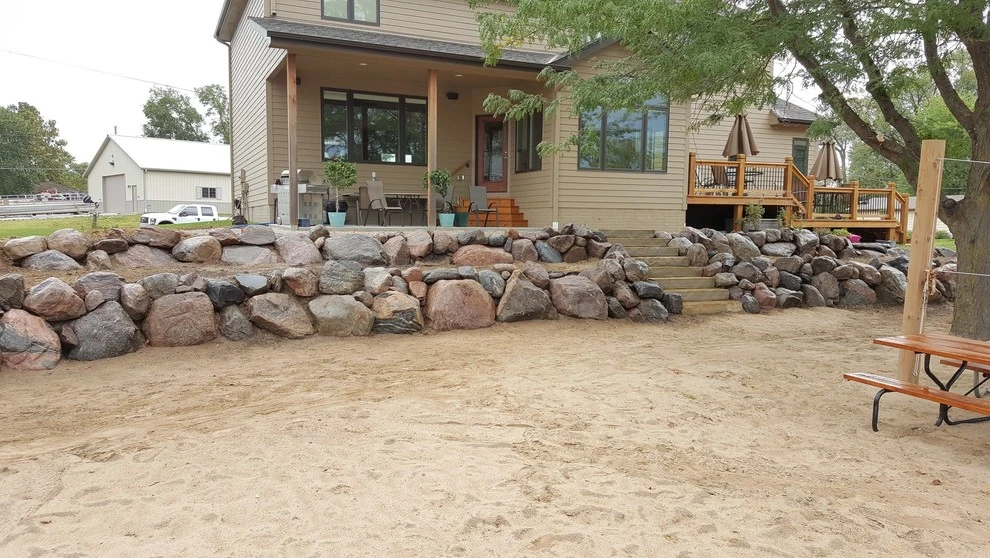 Boulder Retaining Wall by Above And Beyond Complete Grounds Maintenance - Photo 2