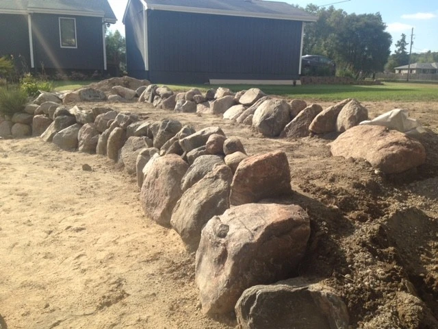 Boulder Retaining Wall by Above And Beyond Complete Grounds Maintenance - Photo 10