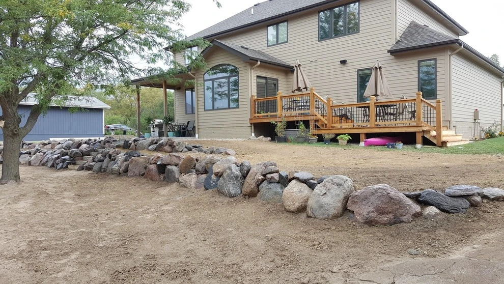 Boulder Retaining Wall by Above And Beyond Complete Grounds Maintenance - Photo 5