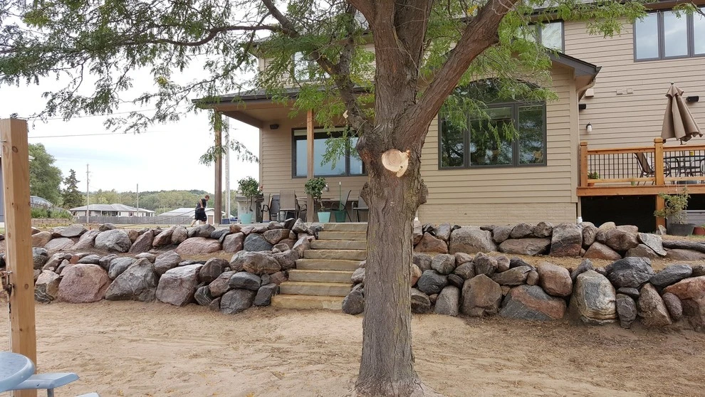 Boulder Retaining Wall by Above And Beyond Complete Grounds Maintenance - Photo 4