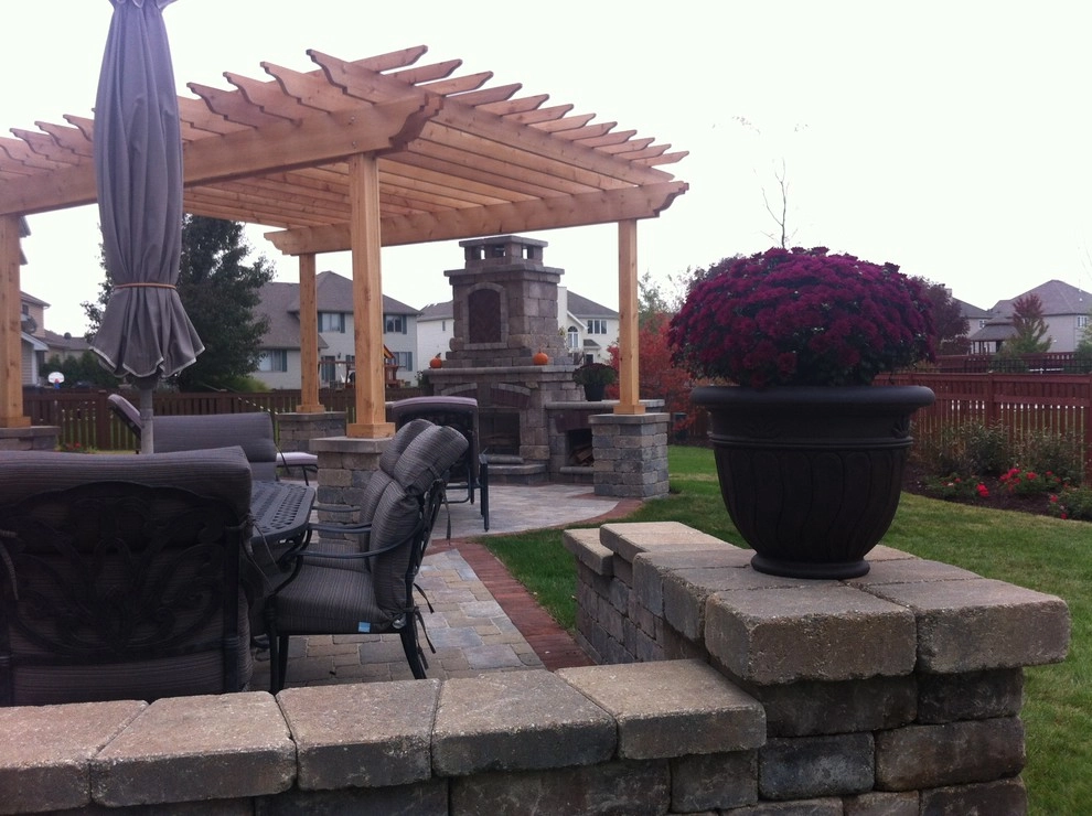 Paver patio with fireplace and pergola by Hively Landscaping Inc. - Photo 3