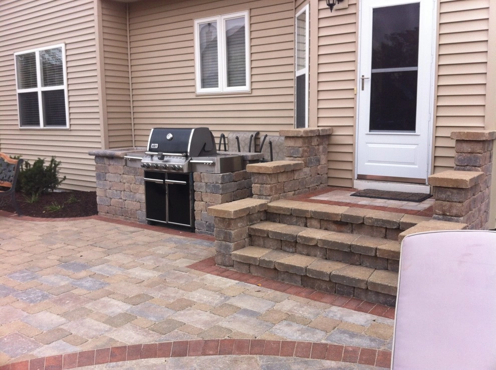 Paver patio with fireplace and pergola by Hively Landscaping Inc. - Photo 2