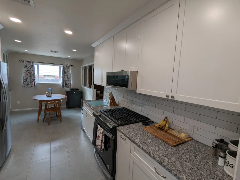 Modern Kitchen Renovation Featuring New White Cabinets by Kitchen Solvers Of Oklahoma City - Photo 5