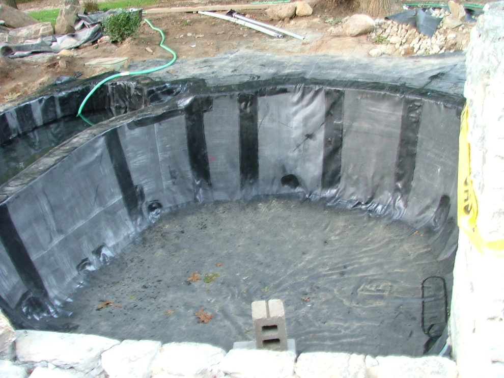 Main driveway with koi ponds on both sides . by Koi Villa Water Garden Center - Photo 5