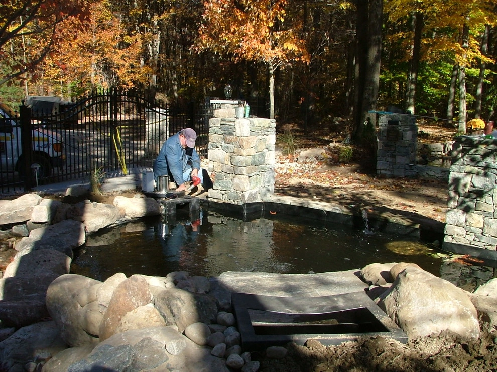Main driveway with koi ponds on both sides . by Koi Villa Water Garden Center - Photo 19