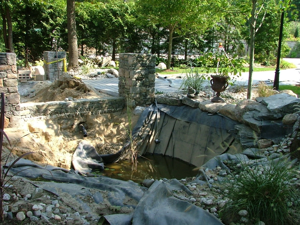 Main driveway with koi ponds on both sides . by Koi Villa Water Garden Center - Photo 8