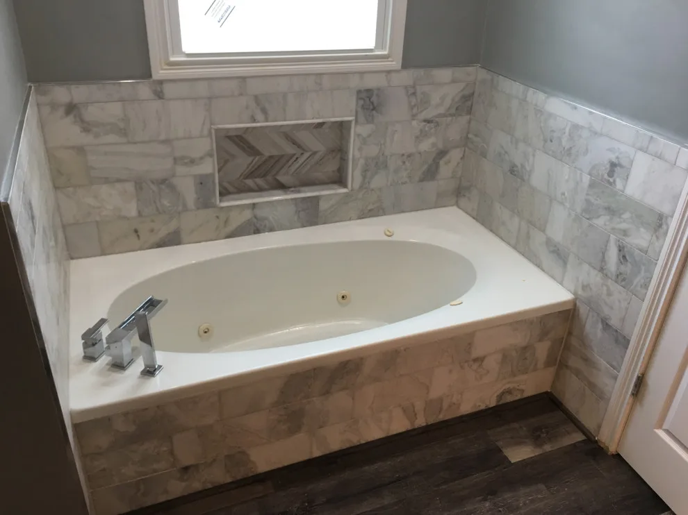 Basement apartment backsplash, updated master bathroom, bedroom flooring by Spencer Remodeling - Photo 14