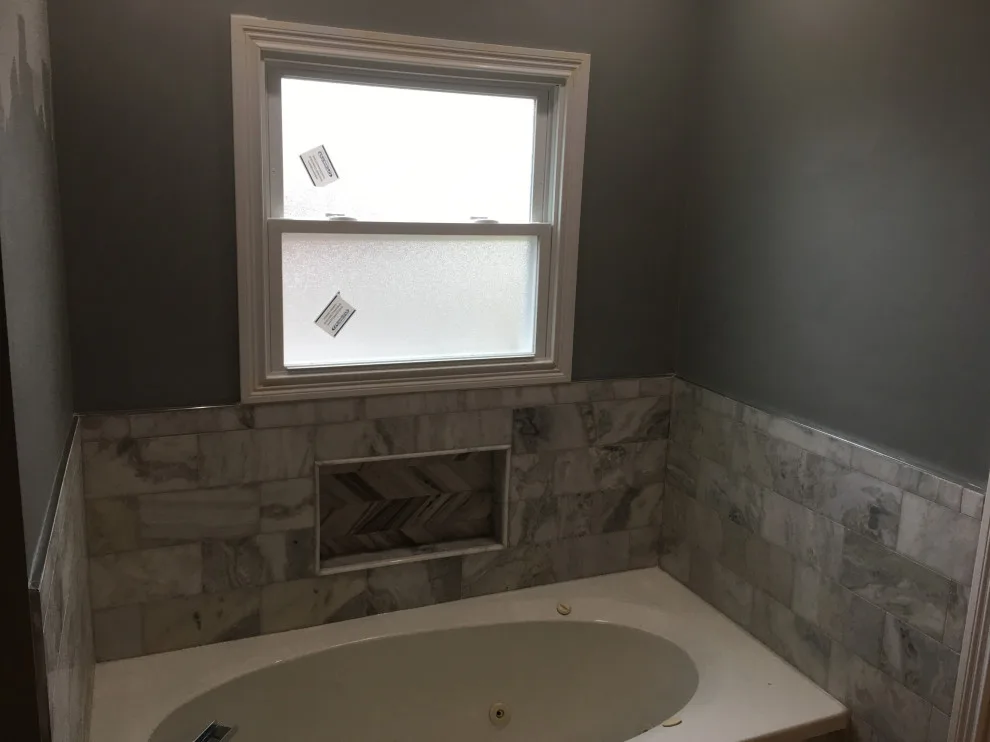 Basement apartment backsplash, updated master bathroom, bedroom flooring by Spencer Remodeling - Photo 10