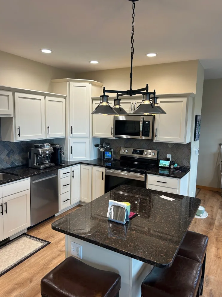 Elegant Kitchen Renovation Featuring Ivory Cabinets by Kitchen Solvers Of Eau Claire - Photo 6