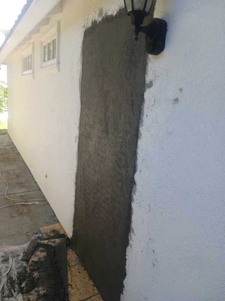 stucco wall where the door was removed by Rigos Painting Services - Photo 2