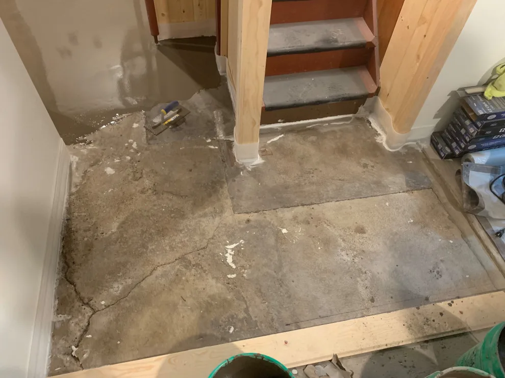 Basement leveling and flooring installation (Before and After) by Ultimate Remodeling - Photo 3