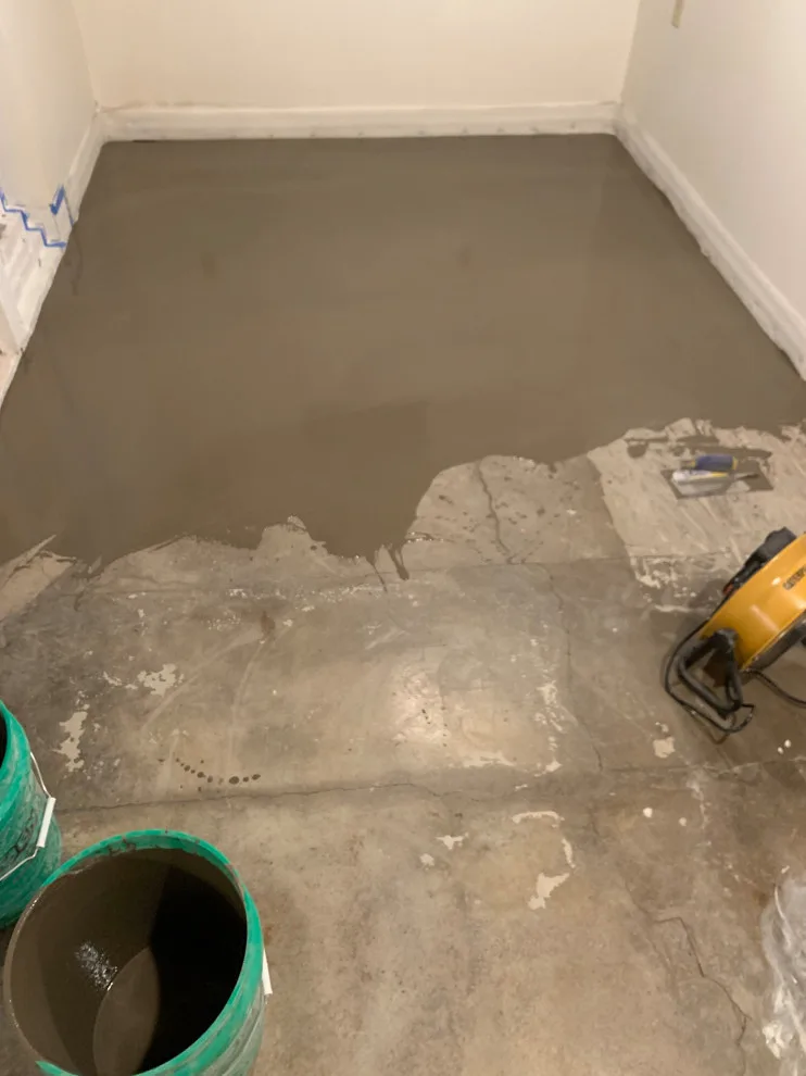 Basement leveling and flooring installation (Before and After) by Ultimate Remodeling - Photo 4