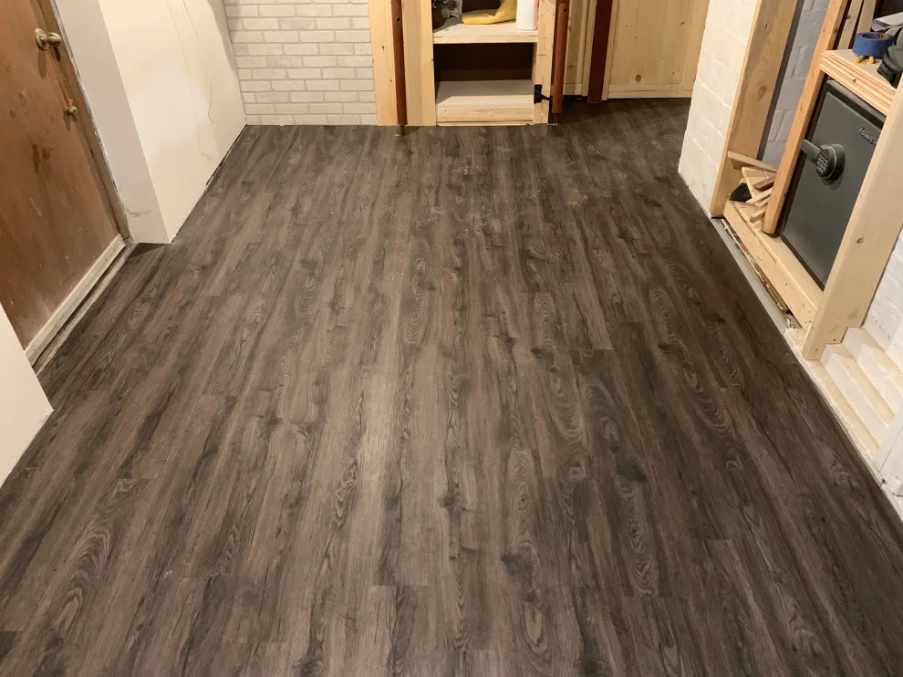 Basement leveling and flooring installation (Before and After) by Ultimate Remodeling - Photo 2