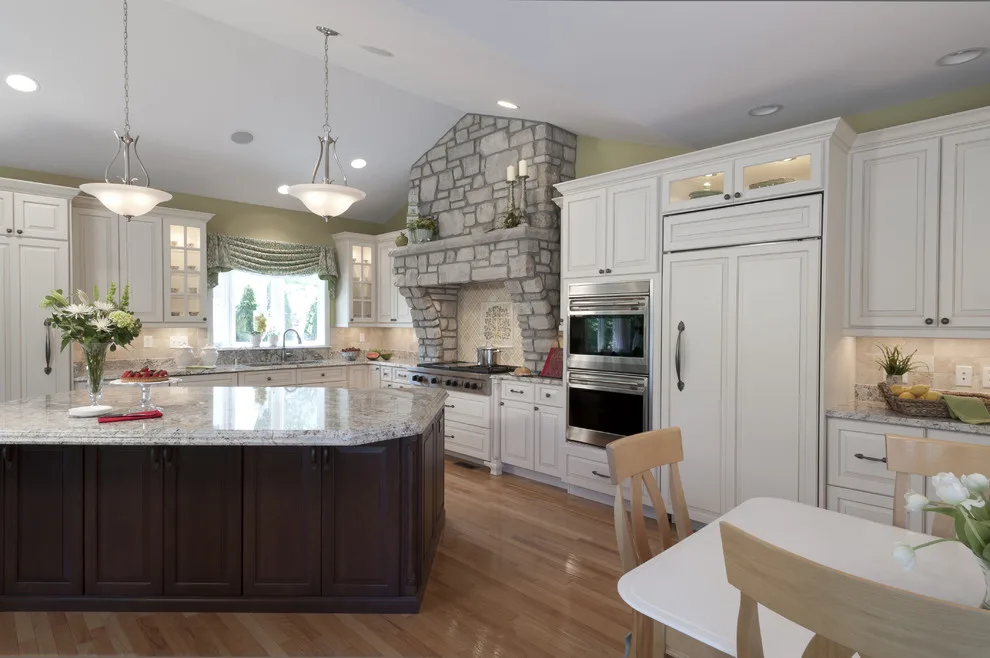 Classic Kitchen with Large Stone Vent Hood by Lorrien Homes & Remodeling - Photo 7