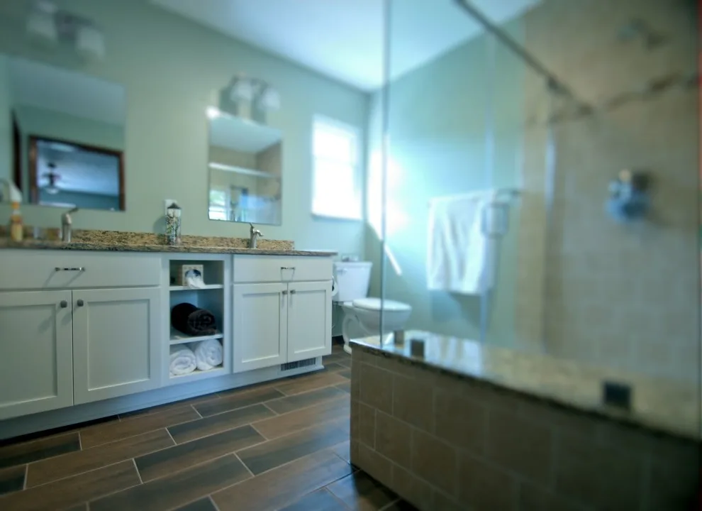 Stylish Country Bathroom Featuring Spacious Shower by Bathroom And Kitchen Services, LLC - Photo 4