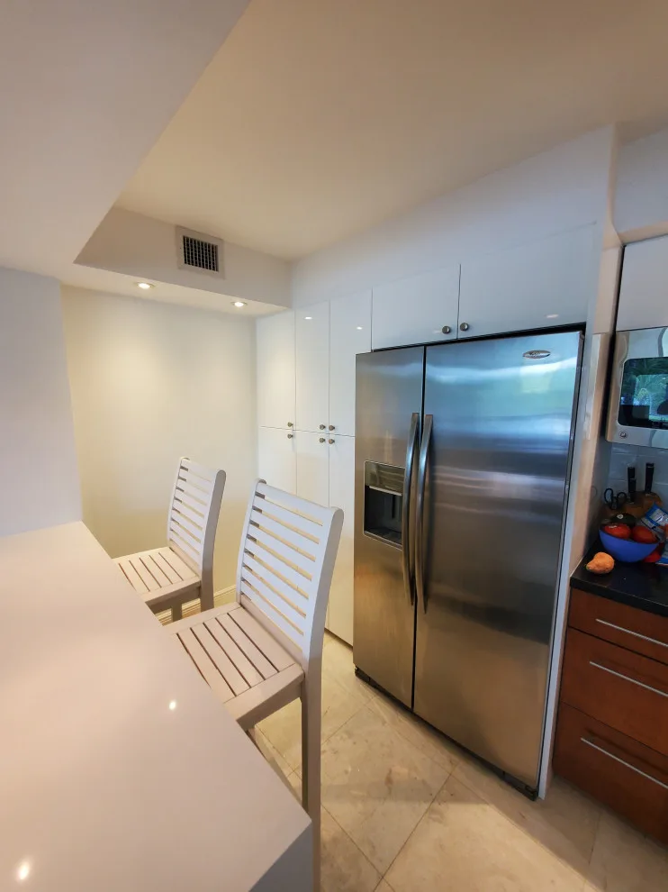 Contemporary Kitchen Renovation Featuring a Glossy White Finish by Kitchen Solvers Of Fort Lauderdale - Photo 10