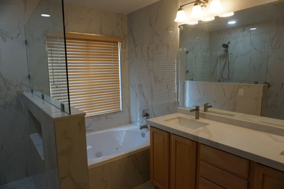 Silver and white marble bathroom renovation by Amos Tile LV - Photo 8