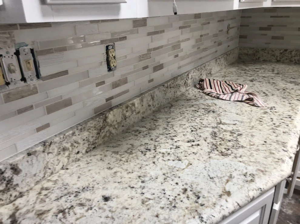 Installation of kitchen backsplash tiles by Uptown Construction - Photo 2