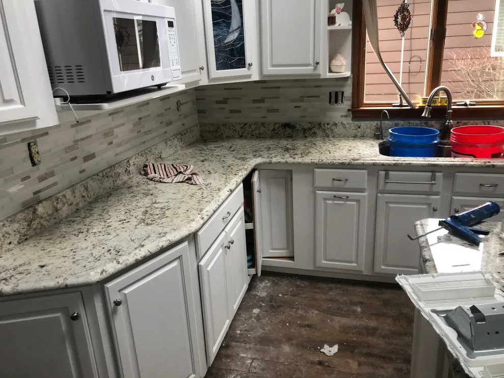 Installation of kitchen backsplash tiles by Uptown Construction - Photo 3