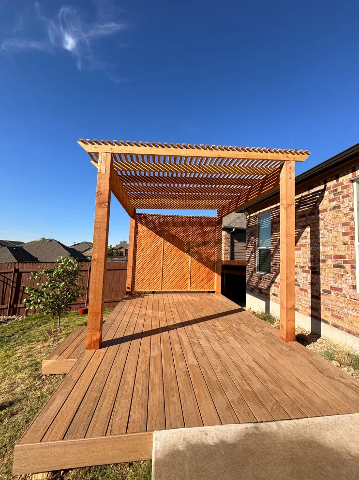 Stunning composite deck featuring a rustic cedar pergola by ATX Outdoor Construction LLC - Photo 2