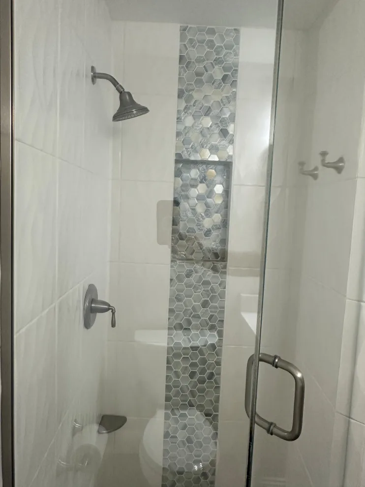 Compact master bathroom makeover featuring a bespoke tile shower and custom glass enclosure by Bolton Home Remodelers - Photo 9