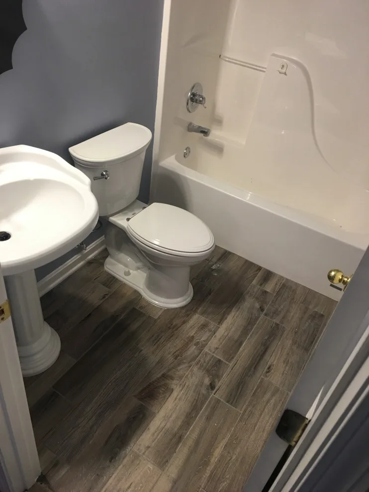 Primary bathroom and new hallway bath flooring by Spencer Remodeling - Photo 9