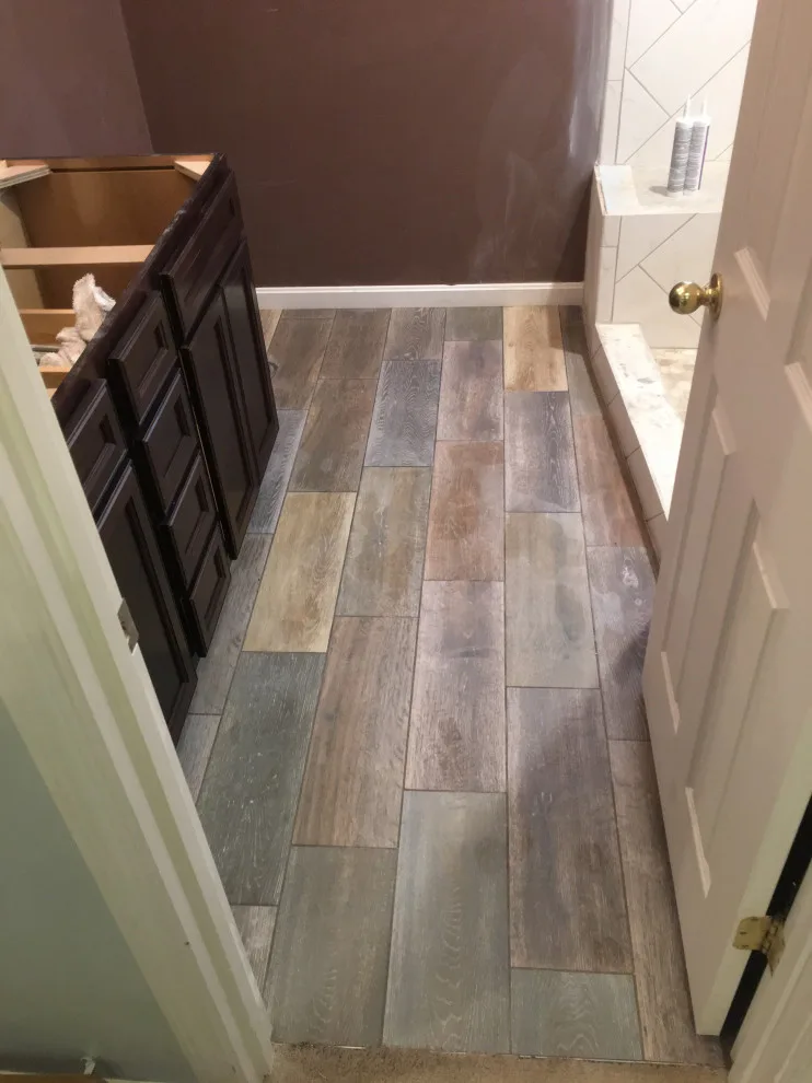 Primary bathroom and new hallway bath flooring by Spencer Remodeling - Photo 3