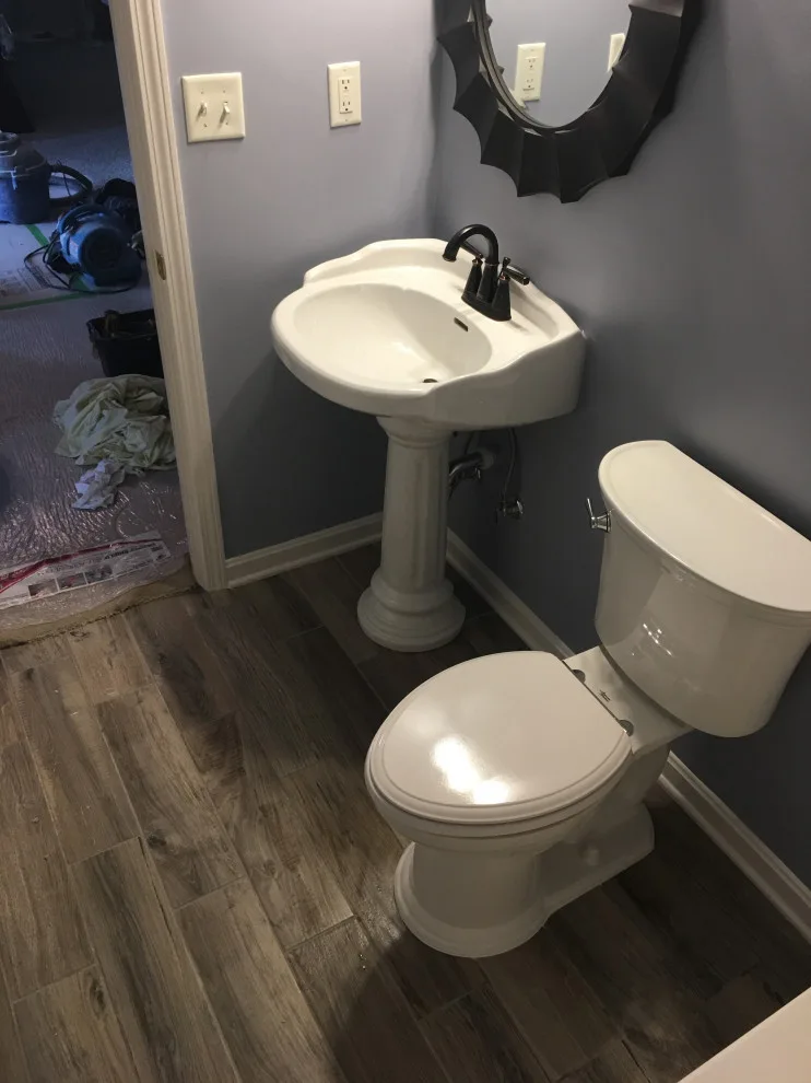 Primary bathroom and new hallway bath flooring by Spencer Remodeling - Photo 5