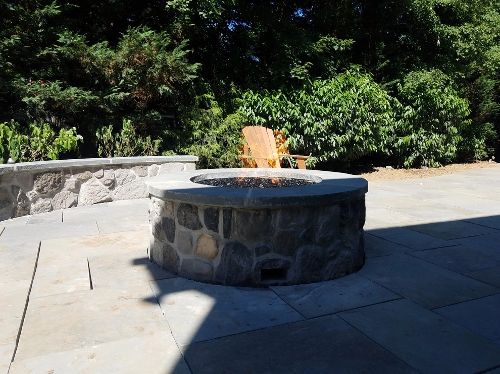 Patio with stone wall and fire pit by Z.O. Landscaping - Photo 3
