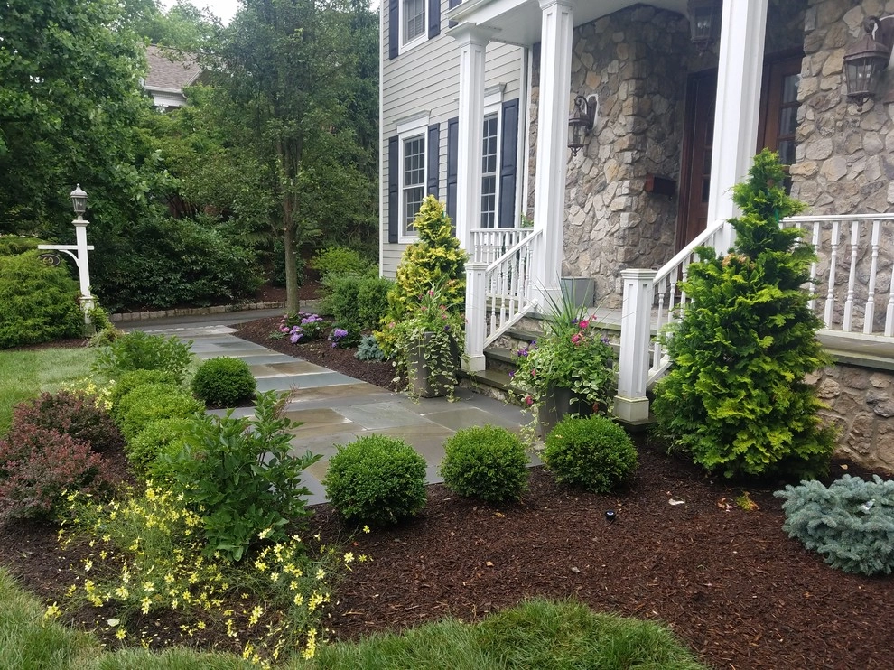 Patio with stone wall and fire pit by Z.O. Landscaping - Photo 7