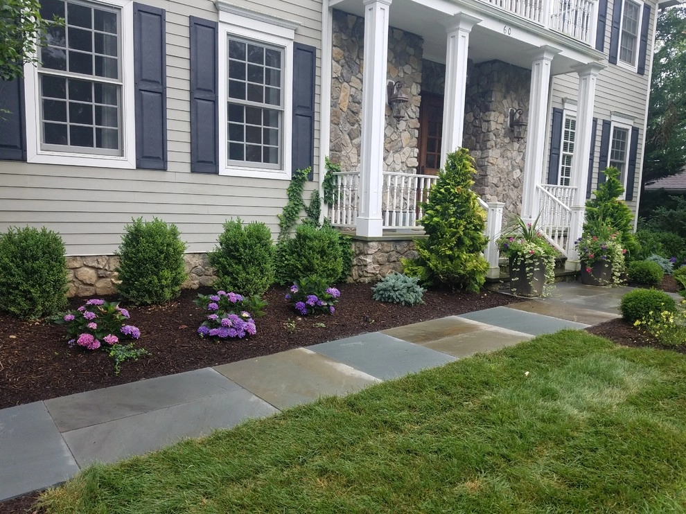 Patio with stone wall and fire pit by Z.O. Landscaping - Photo 12