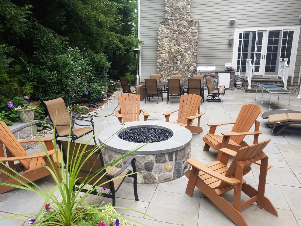 Patio with stone wall and fire pit by Z.O. Landscaping - Photo 11