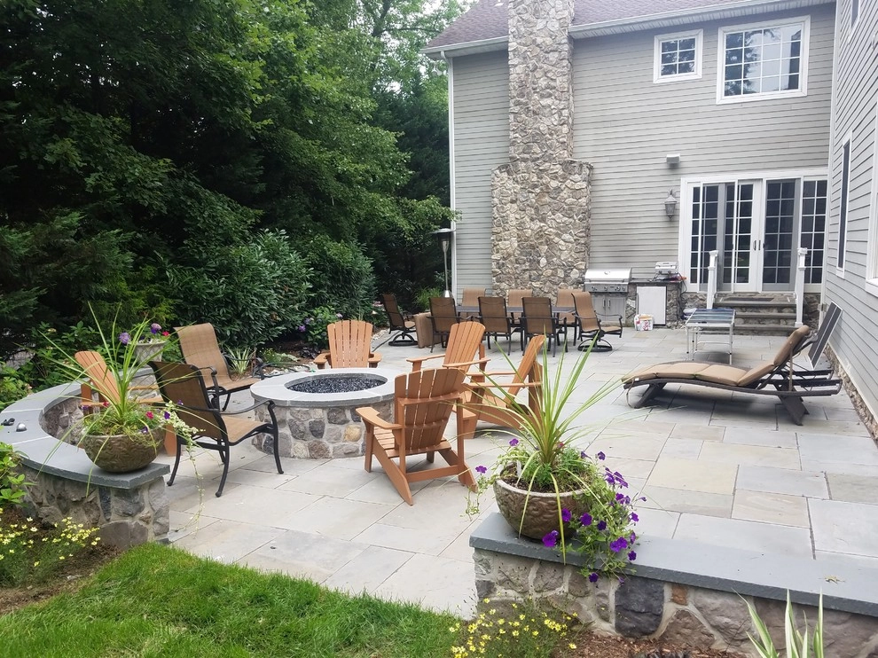Patio with stone wall and fire pit by Z.O. Landscaping - Photo 6