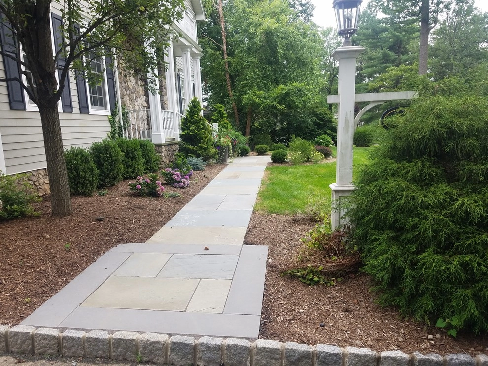 Patio with stone wall and fire pit by Z.O. Landscaping - Photo 10