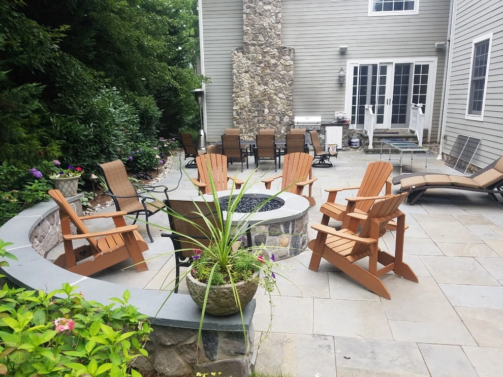 Patio with stone wall and fire pit by Z.O. Landscaping - Photo 4