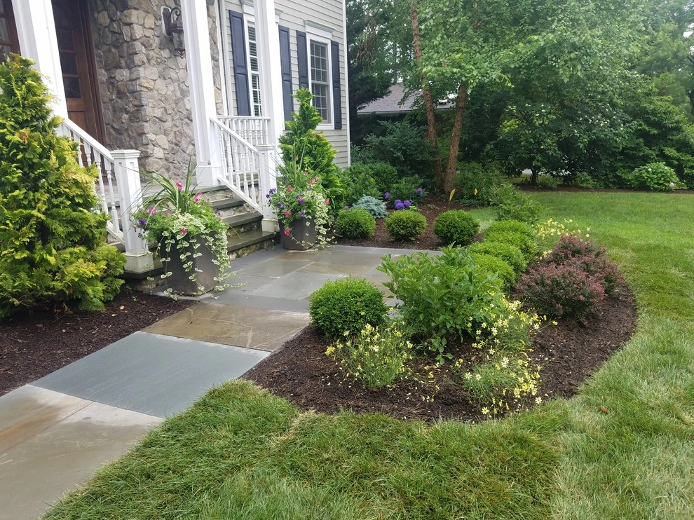 Patio with stone wall and fire pit by Z.O. Landscaping - Photo 5