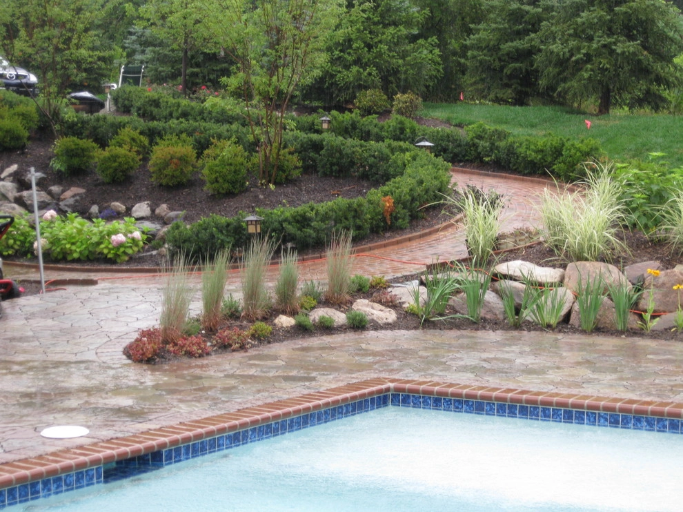 Outdoor Kitchen with fireplace by the pool by Apex Landscape And Brick Services LLC - Photo 7