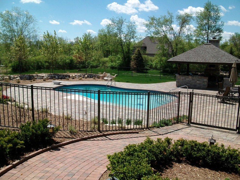 Outdoor Kitchen with fireplace by the pool by Apex Landscape And Brick Services LLC - Photo 2