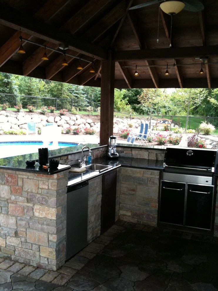 Outdoor Kitchen with fireplace by the pool by Apex Landscape And Brick Services LLC - Photo 6