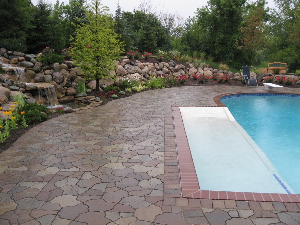 Outdoor Kitchen with fireplace by the pool by Apex Landscape And Brick Services LLC - Photo 3