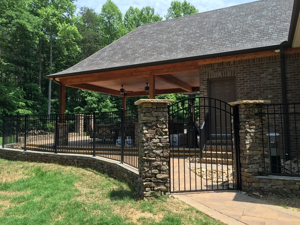Real stone wall veneer around pool with fence by Ayers Hardscapes & Landscapes LLC - Photo 2