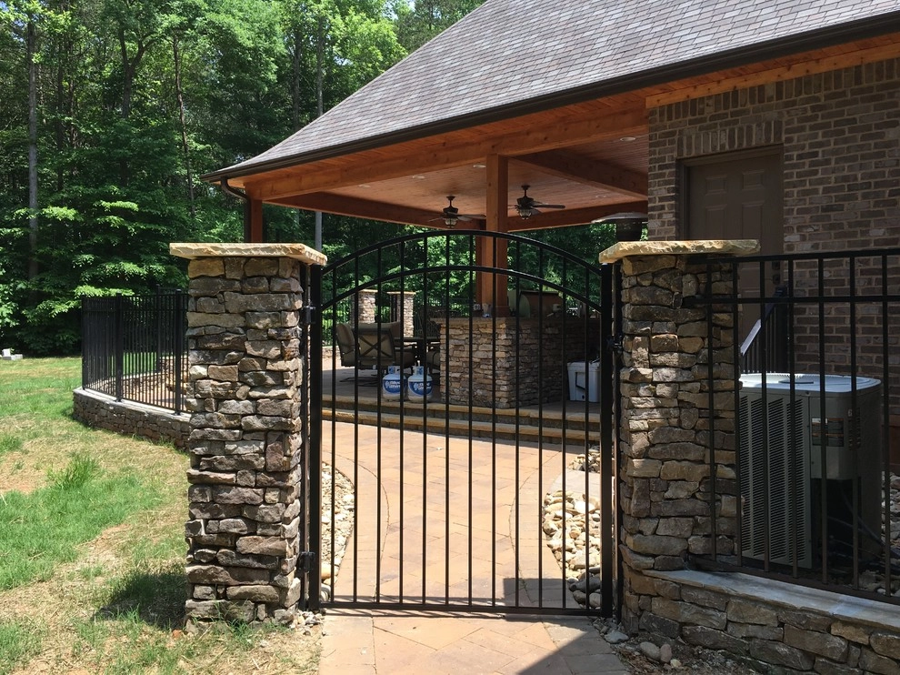 Real stone wall veneer around pool with fence by Ayers Hardscapes & Landscapes LLC - Photo 3