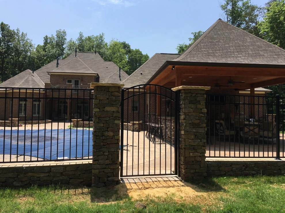 Real stone wall veneer around pool with fence by Ayers Hardscapes & Landscapes LLC - Photo 4