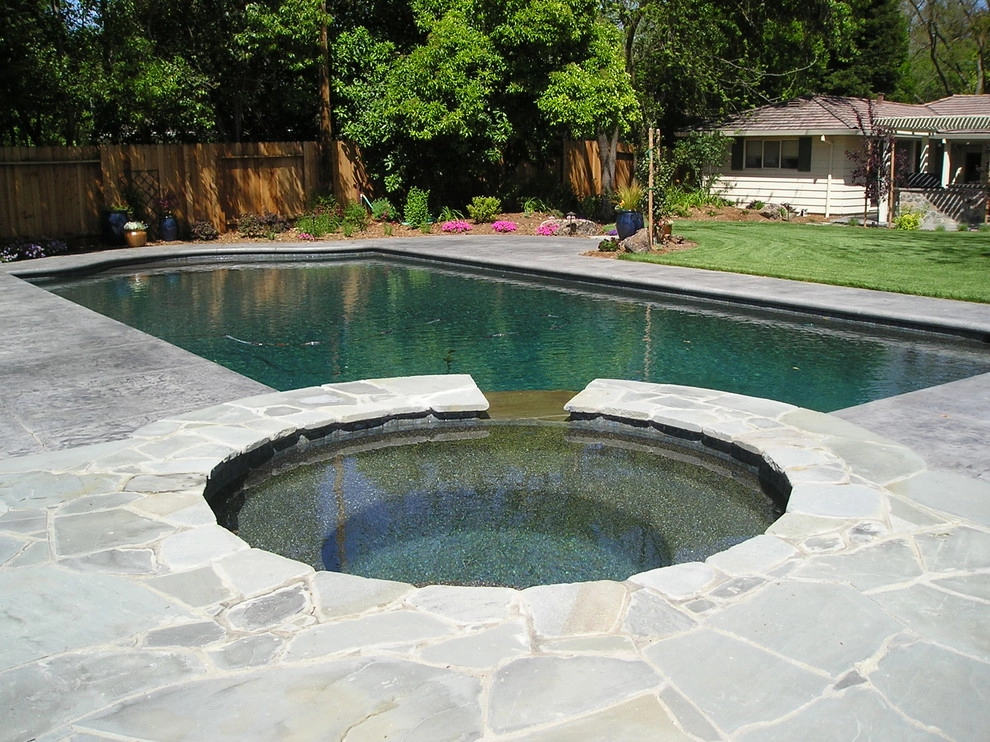 Pool with spa and waterfall by Bluestar Landscape Designers - Photo 2