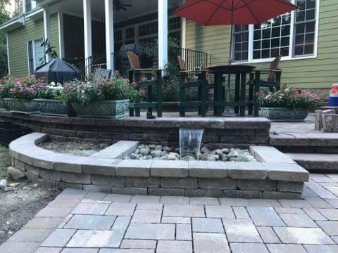 Patio With Water Features and Fireplace by Dreamscape Designers Landscape Company - Photo 5