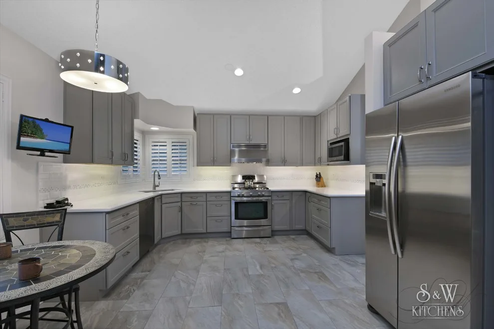 modern kitchen featuring gray cabinetry by Laura Scott - S & W Kitchens - Photo 5