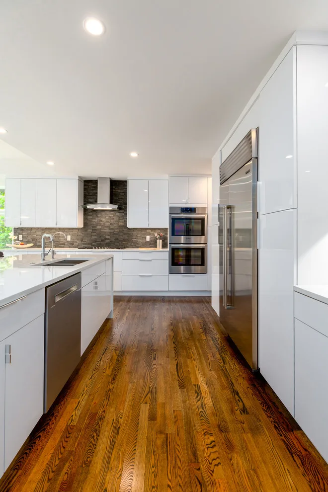 Glossy White Cabinets with White Countertop by Boss Design Center - Photo 13