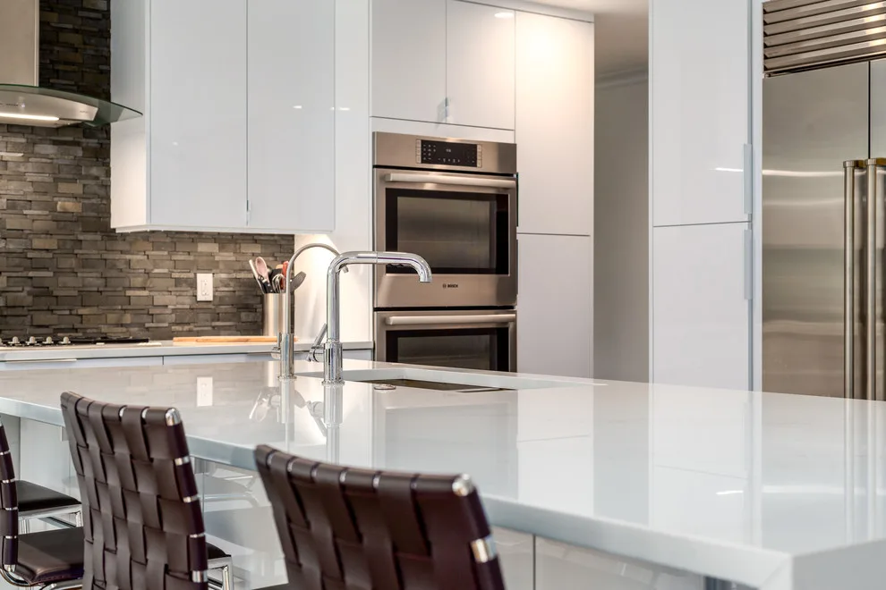 Glossy White Cabinets with White Countertop by Boss Design Center - Photo 9