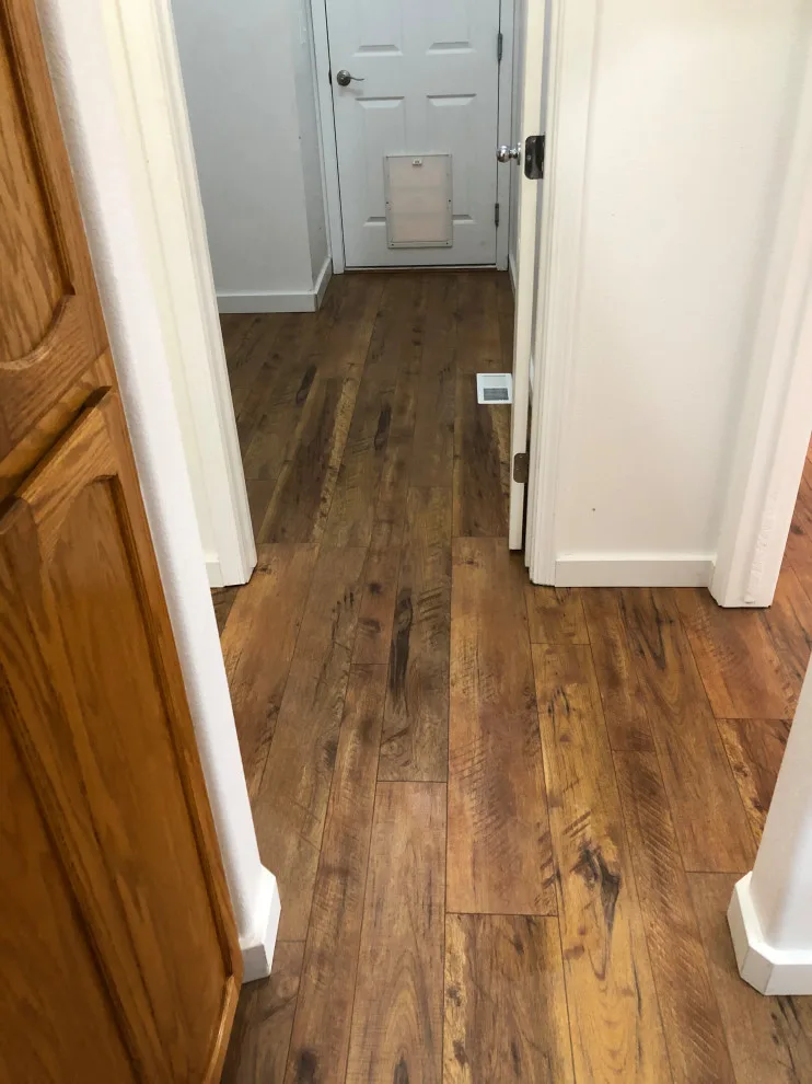 Seamless Laminate Flooring and Baseboards Without Transition Strips by Phoenix Remodeling LLC - Photo 3